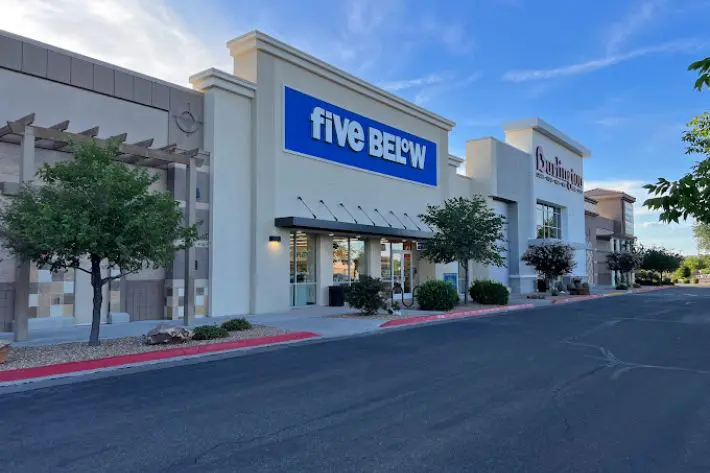Five below (1) A five below store on the side of a street.
